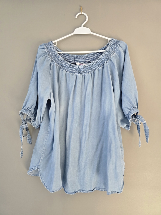 Alia Tops - Light blue denim Peasant Style blouse. Smocked, off-the-shoulder.